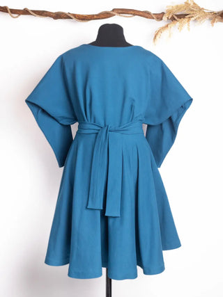 Back view of the Blanche Dress in deep teal – features wide flutter sleeves, adjustable waist tie, and a softly draped silhouette. Handmade by Cori Tailor.