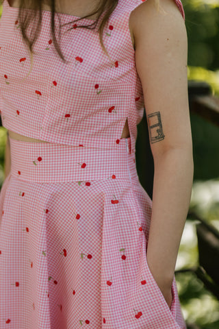 Side detail of the Lolita Top by Cori Tailor, pink gingham cotton with cherry print, structured crop top with side slit and square neckline — summer fashion.