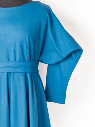Elegant detail of the Blanche Dress in deep teal – wide kimono-style sleeve and gathered waist, crafted for comfort and movement. Handmade by Cori Tailor.