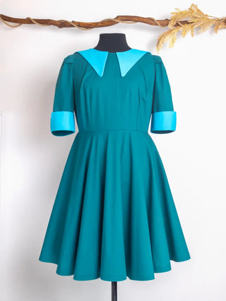 Front view of the Daphne Dress — a bold vintage fit-and-flare silhouette in deep teal, featuring a wide contrast collar and cuffs in light blue. Handmade by Cori Tailor.