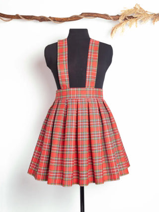 Front view of the Jenny Skirt – handmade high-waisted suspender skirt in red tartan with box pleats and classic schoolgirl vibe by Cori Tailor.
