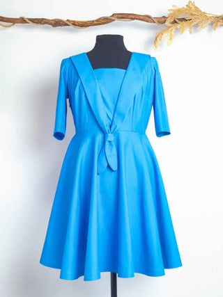 Front view of the Sailor Moon Dress – vintage-style royal blue dress with sailor collar, front tie detail, and full circle skirt. Handmade by Cori Tailor.