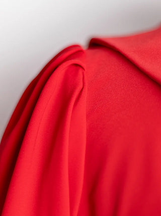 Close-up of the Sophia Dress in vibrant red, highlighting puff shoulder pleats and Peter Pan collar – part of a bold hero contrast on Cori Tailor's mobile homepage.